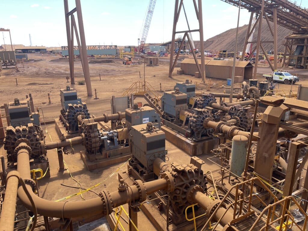 A heavy-duty pump station with multiple industrial pumps, pipelines, and equipment installed at a mining or processing site